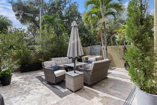 a view of a patio with couches and a fire pit