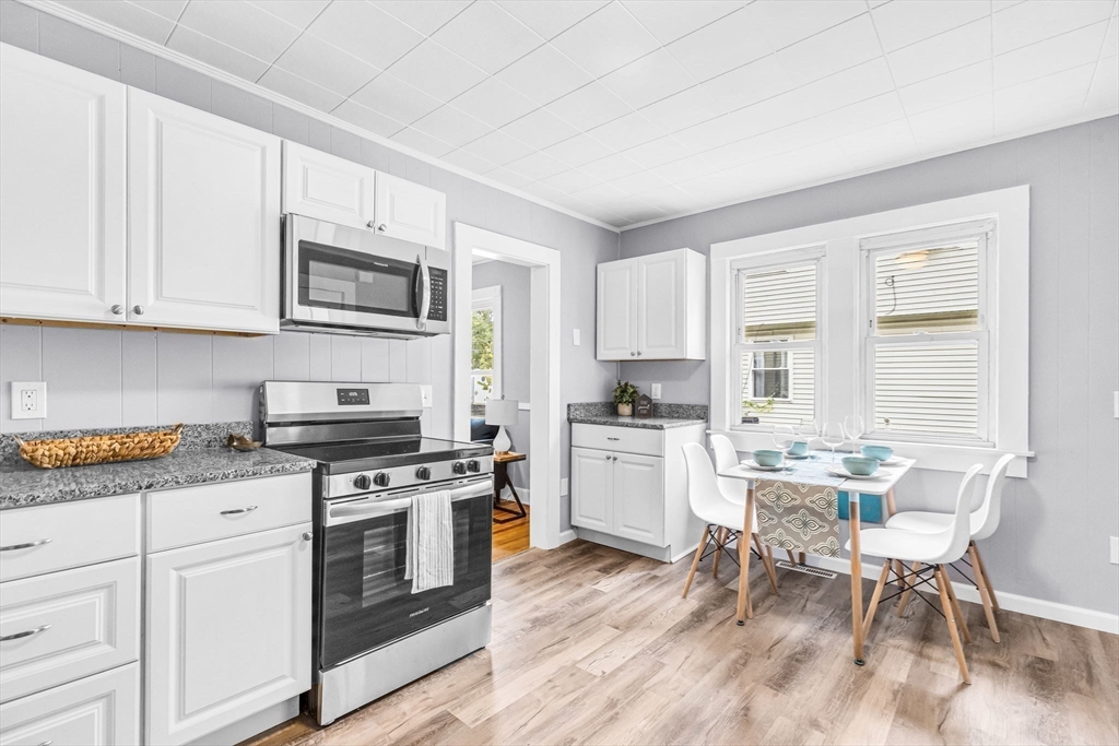 125 Verge Street Springfield, MA 01129 - Photo 11 of 42 a kitchen with granite countertop white cabinets and white appliances