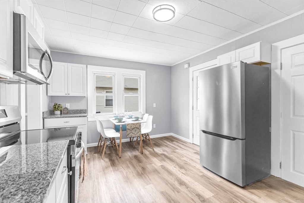 125 Verge Street Springfield, MA 01129 - Photo 12 of 42 a dining room with stainless steel appliances granite countertop a refrigerator microwave and wooden floor