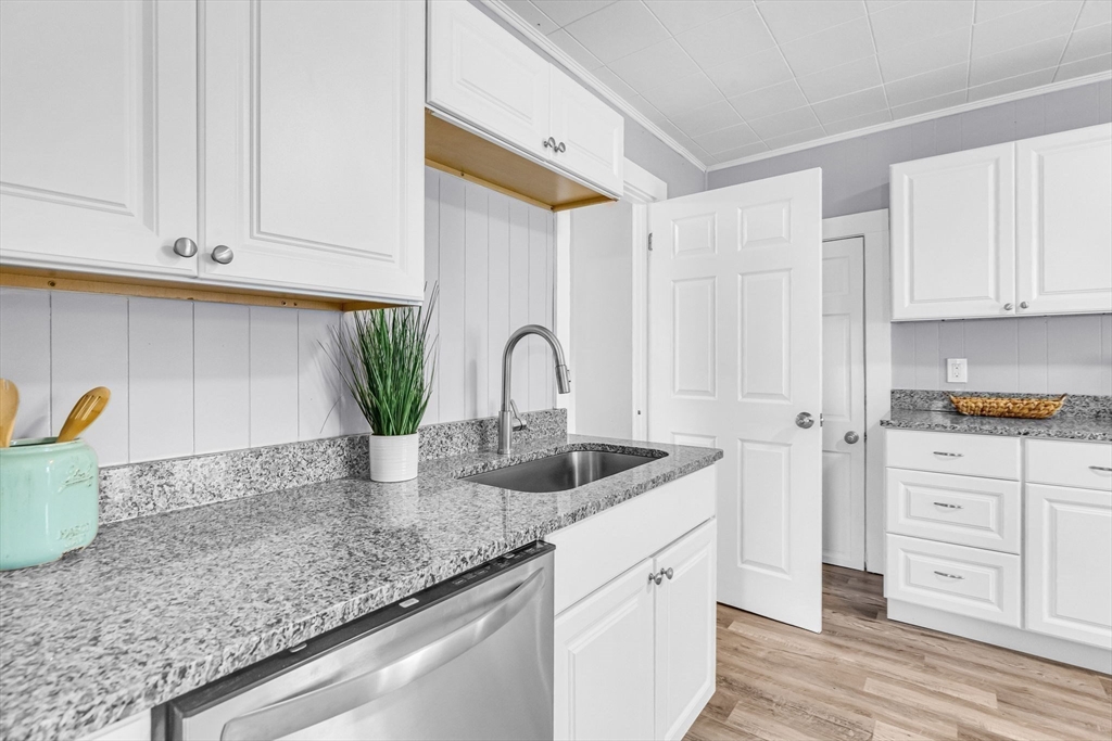 125 Verge Street Springfield, MA 01129 - Photo 14 of 42 a kitchen with granite countertop white cabinets and sink