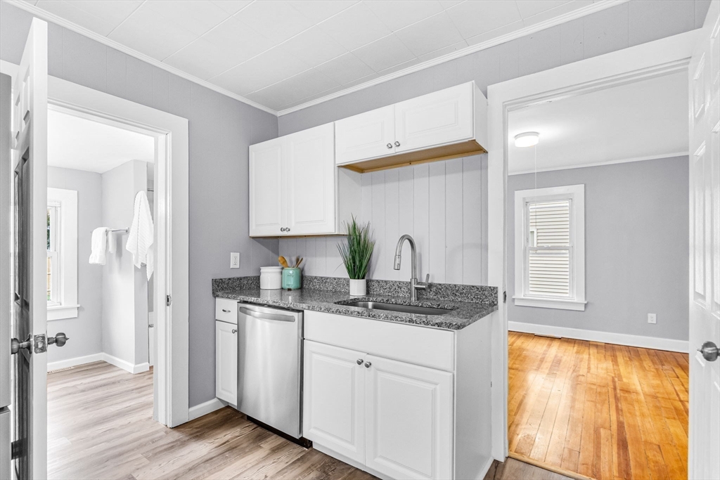 125 Verge Street Springfield, MA 01129 - Photo 15 of 42 a kitchen with stainless steel appliances granite countertop a sink and dishwasher with wooden floor