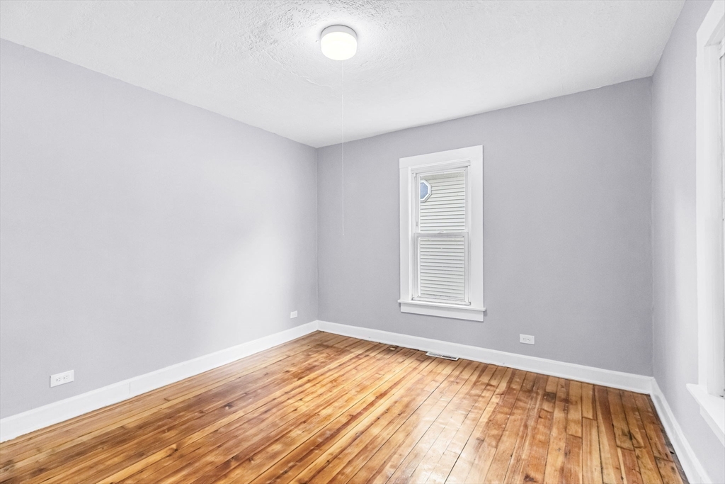 125 Verge Street Springfield, MA 01129 - Photo 19 of 42 an empty room with wooden floor and windows