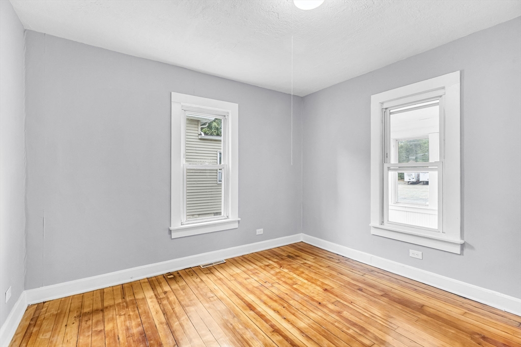 125 Verge Street Springfield, MA 01129 - Photo 23 of 42 a view of an empty room with wooden floor and a window