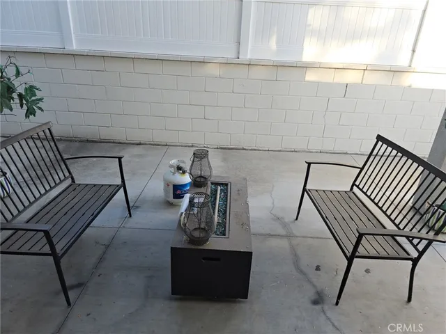 a view of a patio with table and chairs