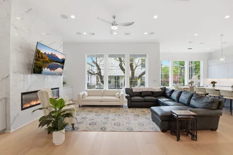 a living room with fireplace furniture and a flat screen tv