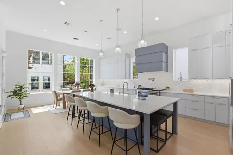 a large kitchen with a table and chairs