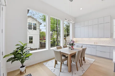a large kitchen with a large counter top appliances and cabinets