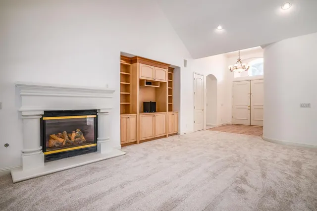 a view of an empty room with a fireplace