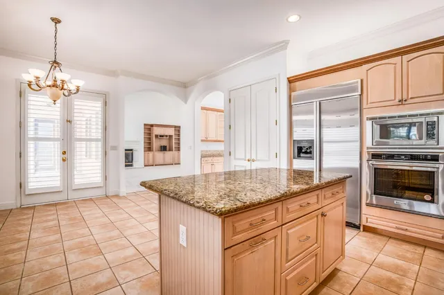 a kitchen with stainless steel appliances granite countertop a sink stove and cabinets