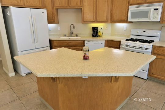 421 Mavis Court Ridgecrest, CA 93555 - Photo 12 of 33 a view of a kitchen with a sink stove and refrigerator