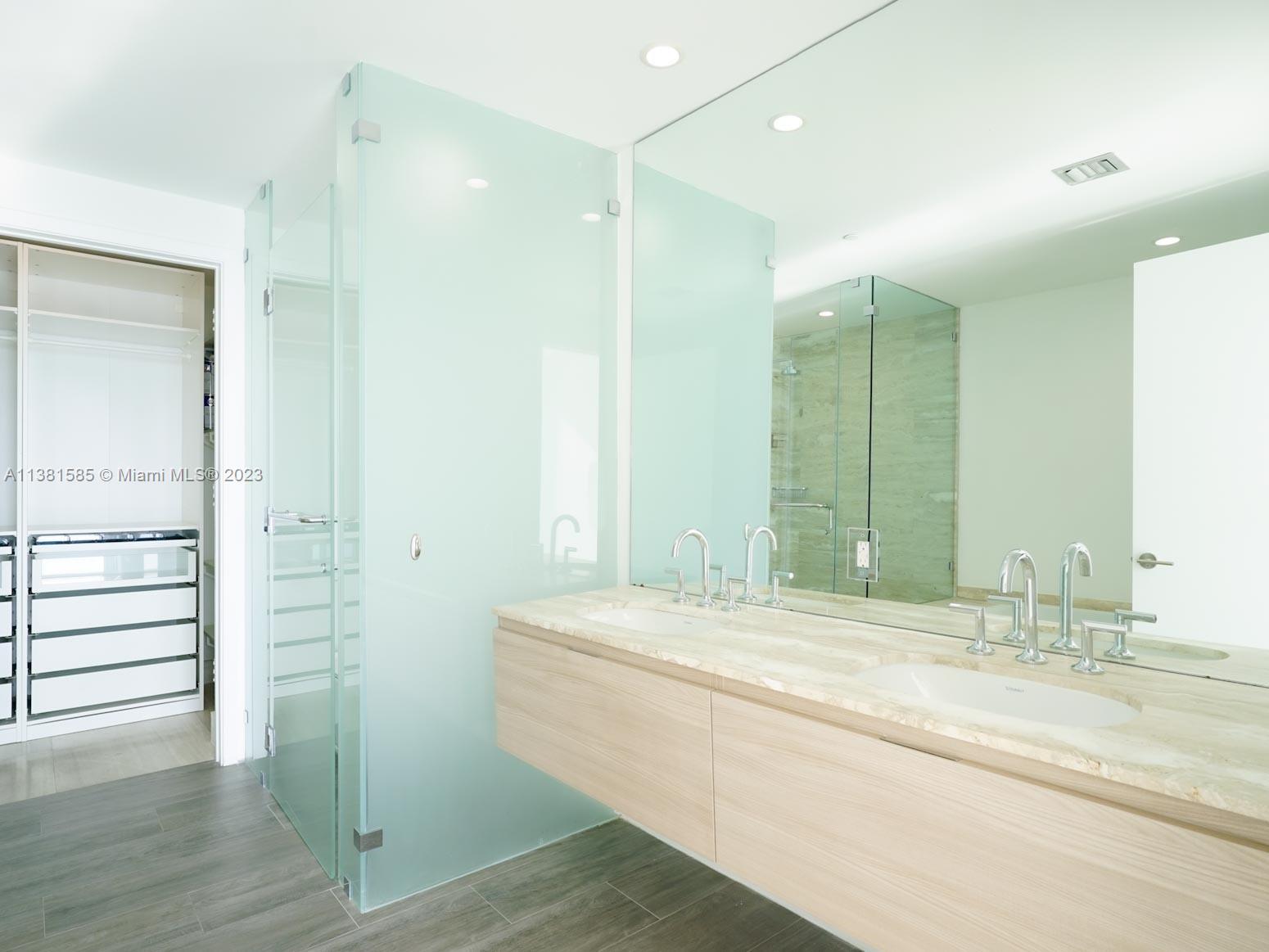 Edgewater Miami, FL 33137 - Photo 12 of 42 a bathroom with a double vanity sink and a mirror