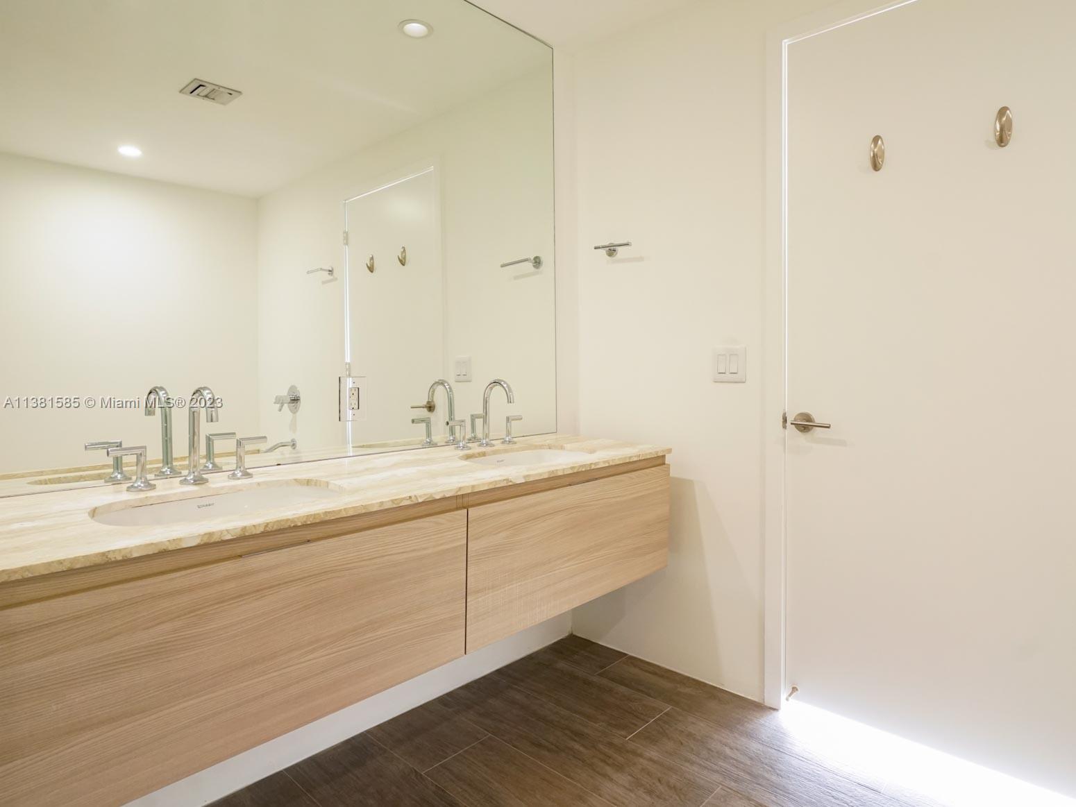 Edgewater Miami, FL 33137 - Photo 14 of 42 a bathroom with a sink and a mirror