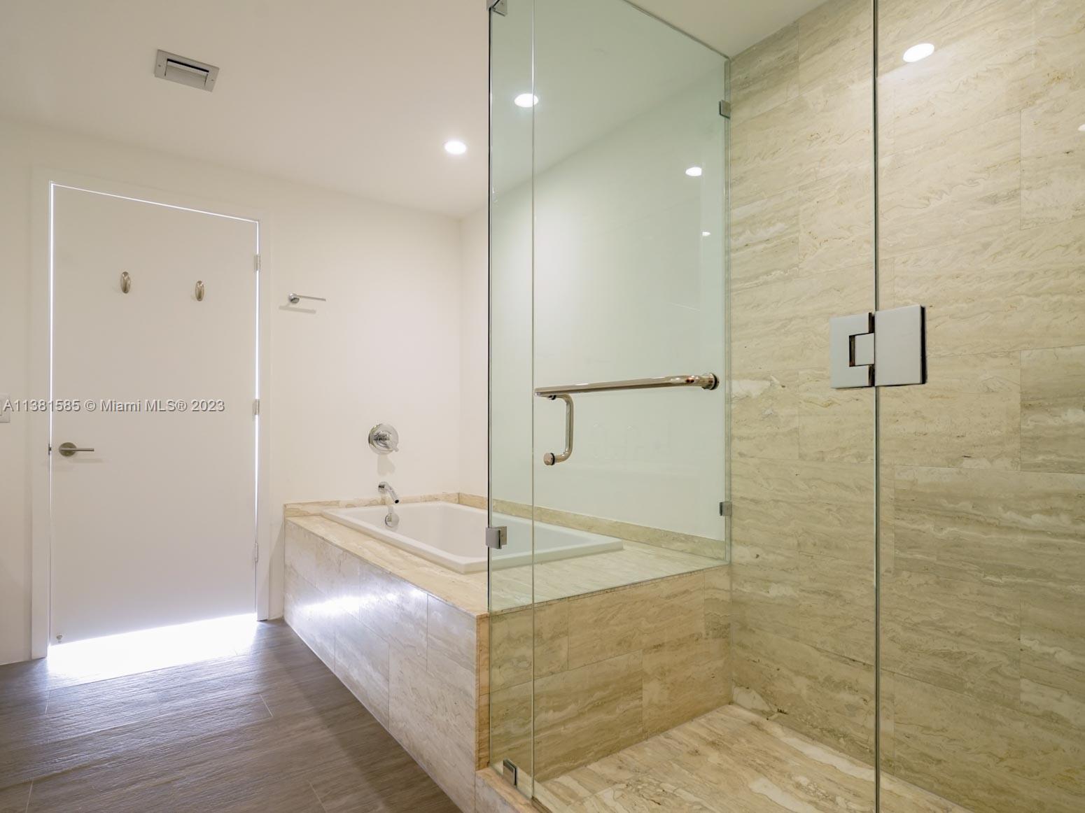 Edgewater Miami, FL 33137 - Photo 17 of 42 a bathroom with a glass shower door and a sink