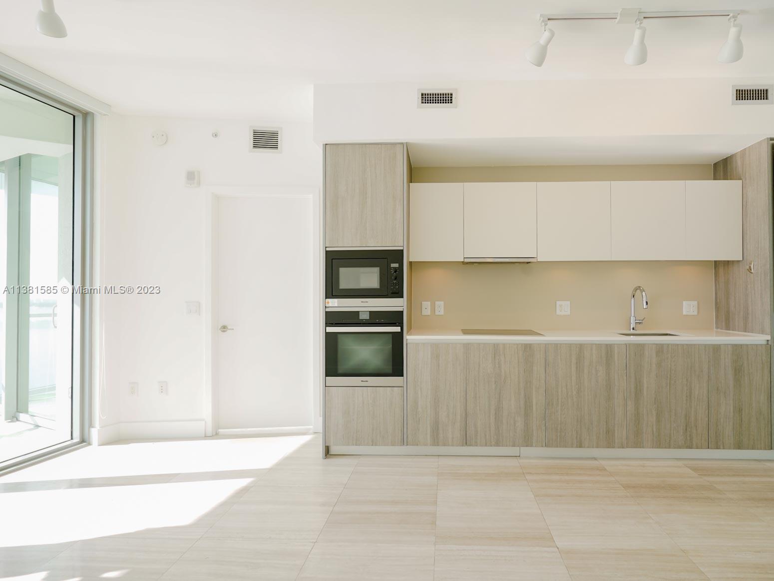 Edgewater Miami, FL 33137 - Photo 20 of 42 a view of kitchen with stainless steel appliances cabinets and a counter top space