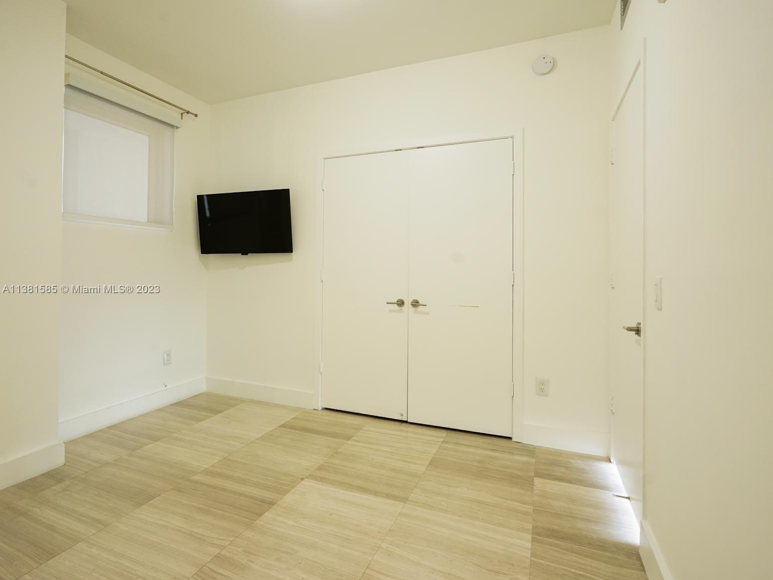 Edgewater Miami, FL 33137 - Photo 26 of 42 a view of a livingroom with wooden floor and a flat screen tv