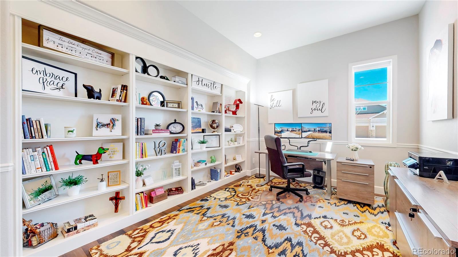20249 Terrace View Drive Parker, CO 80134 - Photo 17 of 38 a workspace with furniture and a book shelf