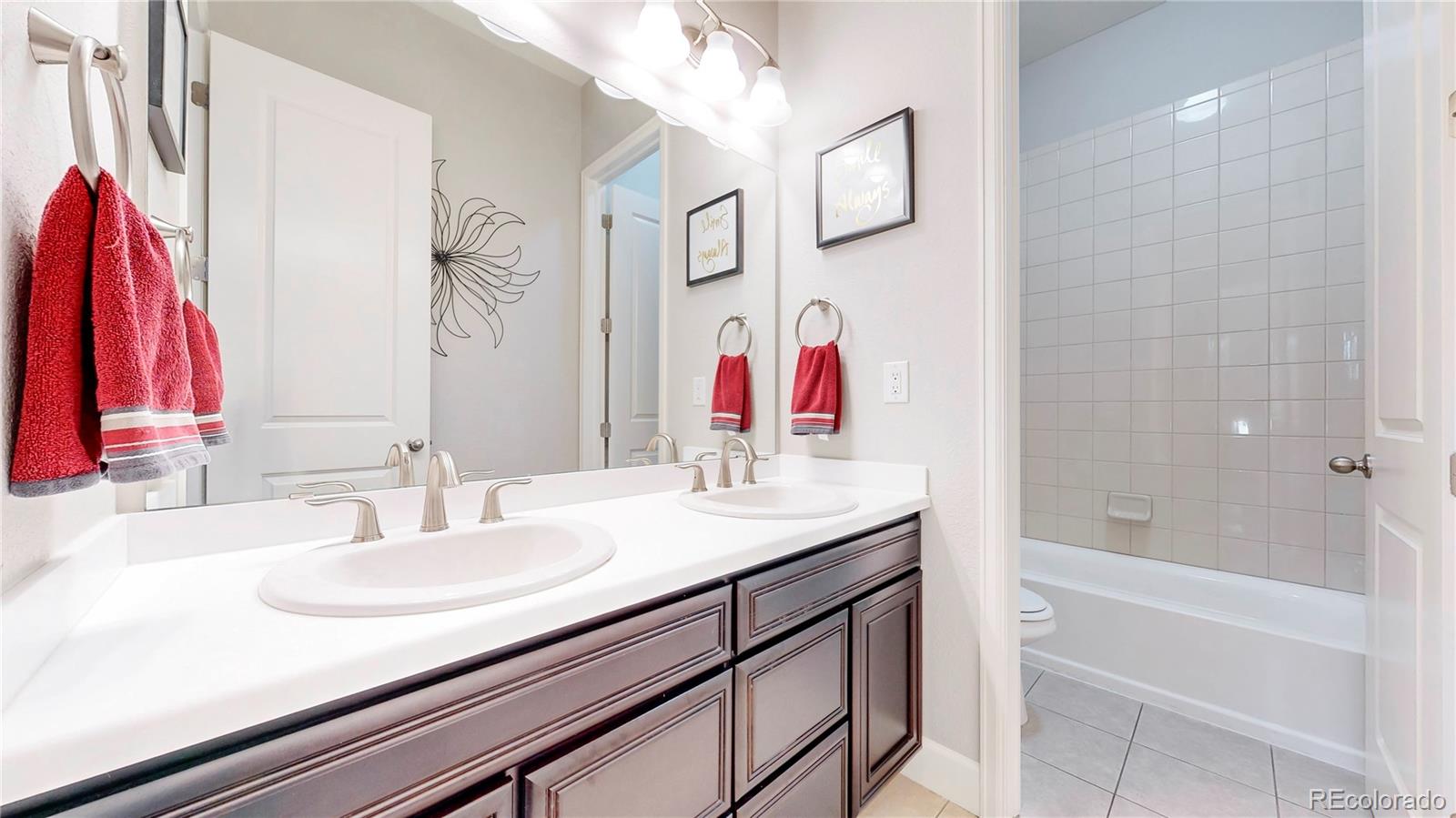 20249 Terrace View Drive Parker, CO 80134 - Photo 21 of 38 a bathroom with a granite countertop sink a shower and a mirror