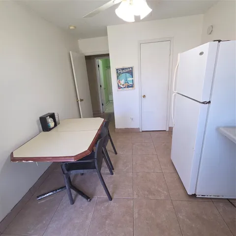 a view of kitchen with furniture and wooden floor