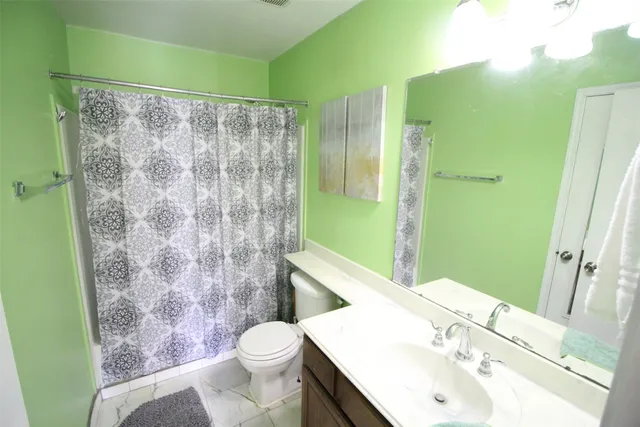 a bathroom with a sink toilet and shower