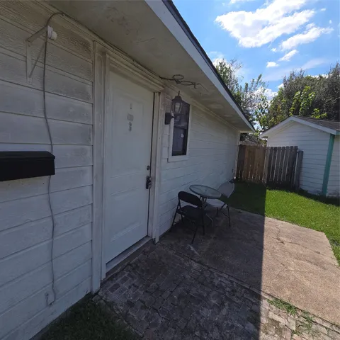 a backyard of a house with table and chairs
