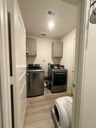 a kitchen with a refrigerator and a stove