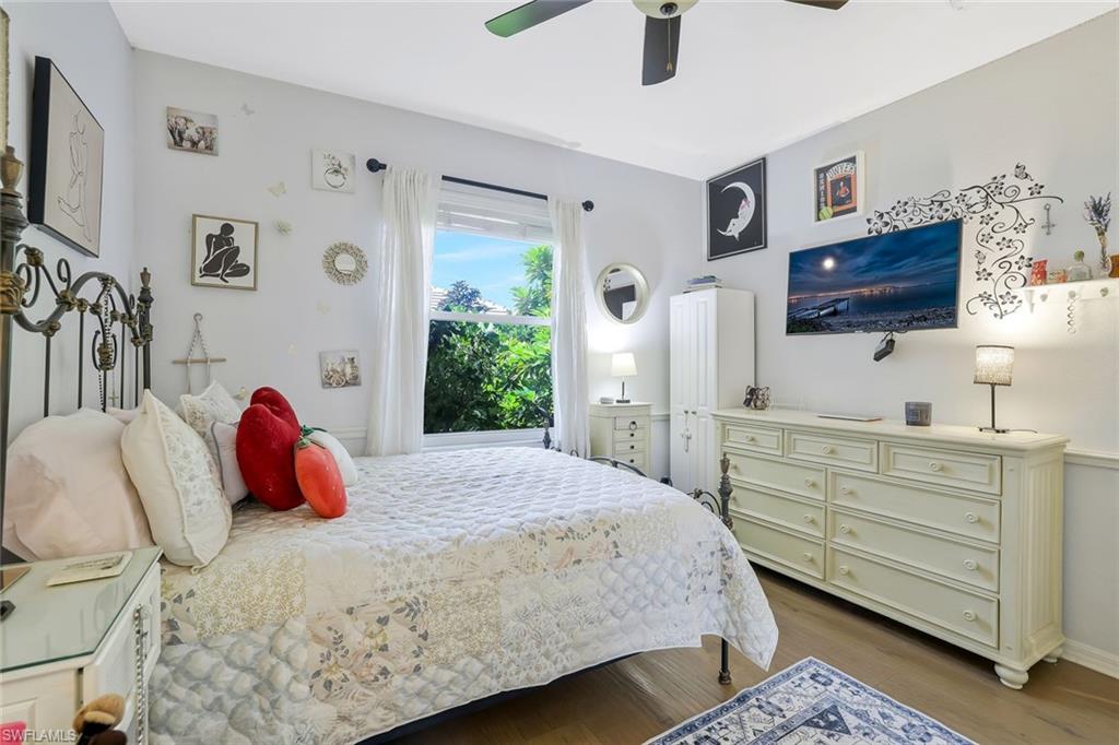 186 Muirfield Circle Naples, FL 34113 - Photo 23 of 32 a bedroom with a bed and a flat tv screen