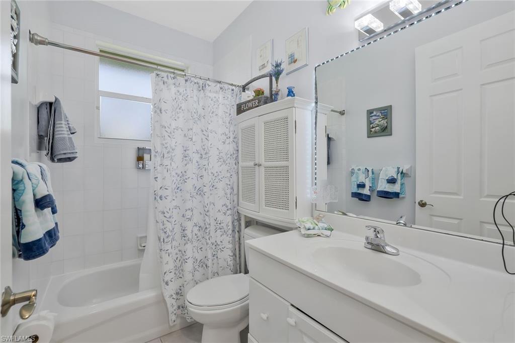 186 Muirfield Circle Naples, FL 34113 - Photo 24 of 32 a bathroom with a sink toilet tub and shower