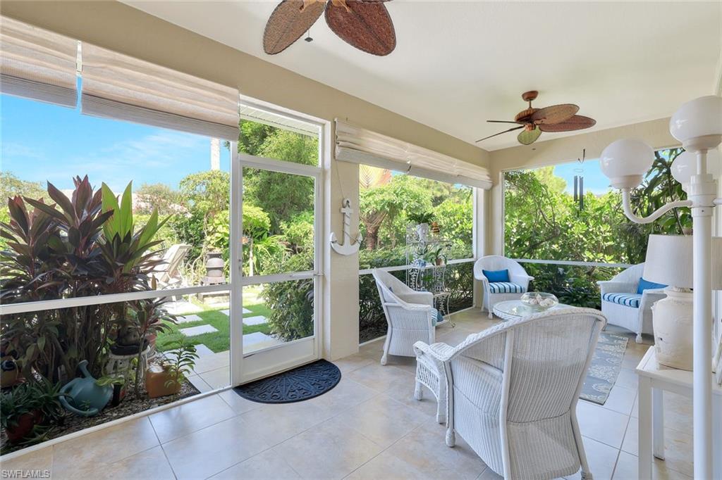 186 Muirfield Circle Naples, FL 34113 - Photo 26 of 32 a living room with furniture and a potted plant