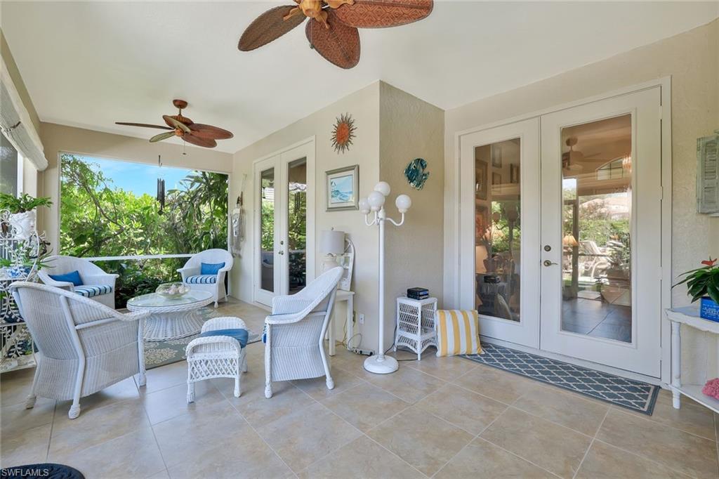 186 Muirfield Circle Naples, FL 34113 - Photo 27 of 32 a living room with furniture and a large window