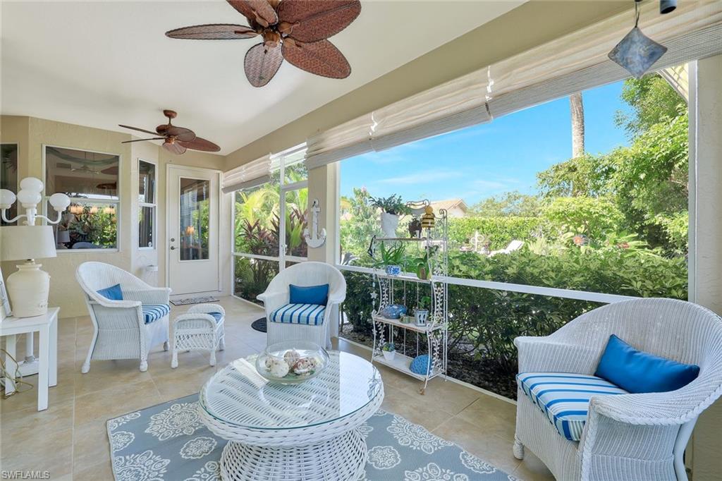 186 Muirfield Circle Naples, FL 34113 - Photo 28 of 32 a living room with furniture and a large window