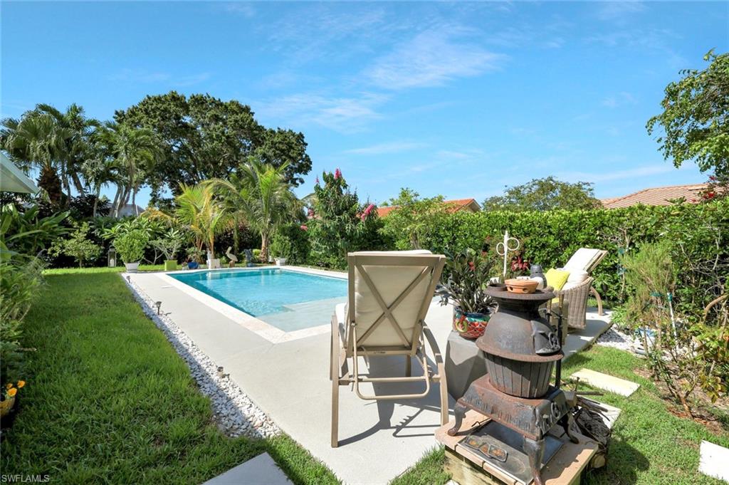 186 Muirfield Circle Naples, FL 34113 - Photo 30 of 32 a view of a chairs and table in the garden