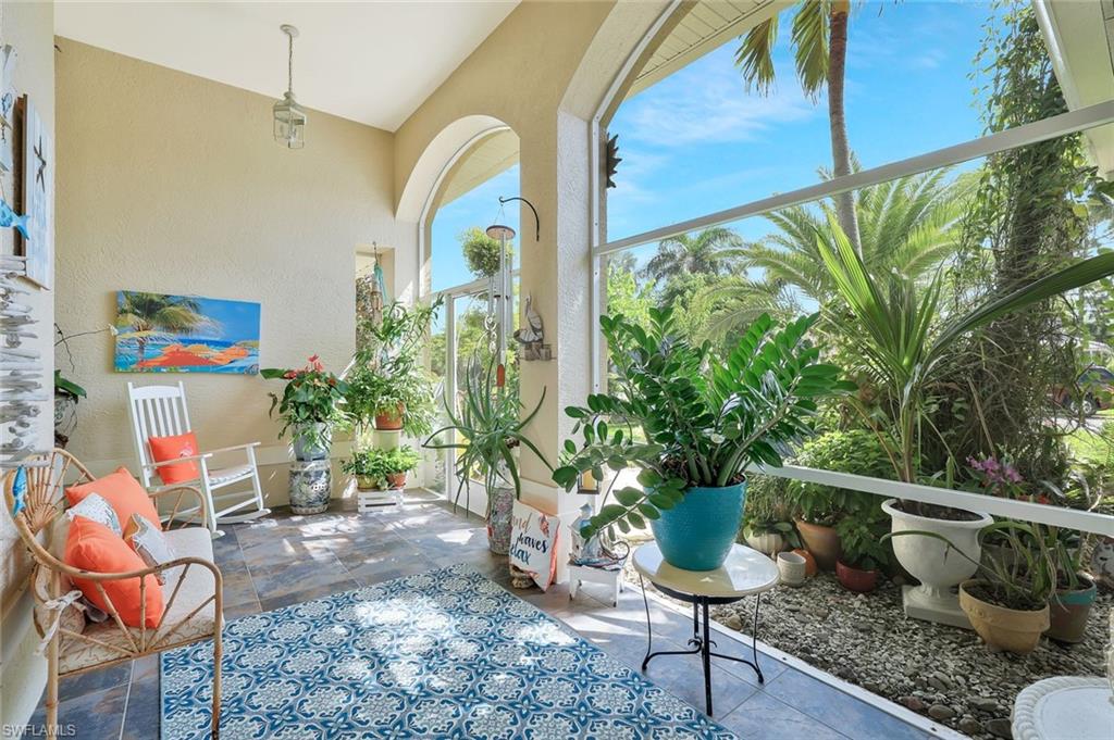 186 Muirfield Circle Naples, FL 34113 - Photo 3 of 32 a view of a porch with chairs and potted plants