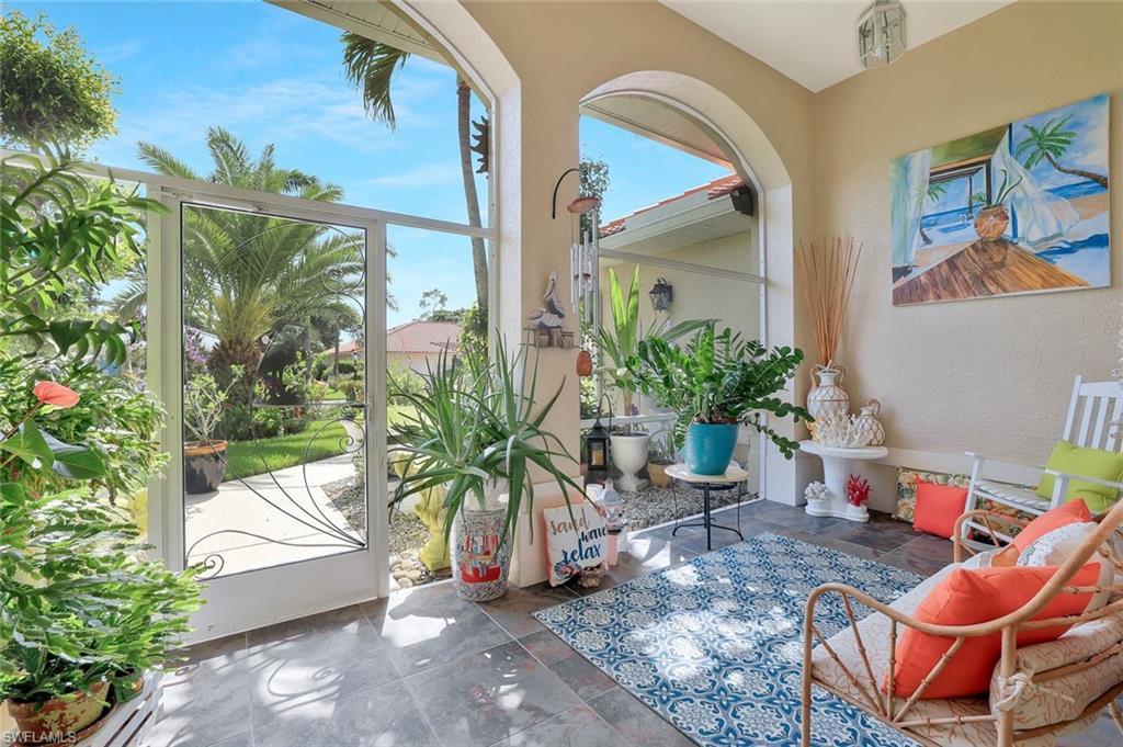 186 Muirfield Circle Naples, FL 34113 - Photo 4 of 32 a vase of flowers sitting on a floor