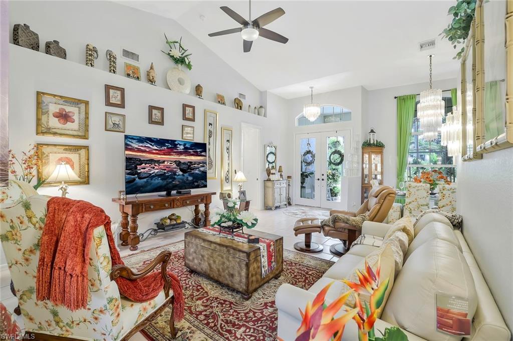 186 Muirfield Circle Naples, FL 34113 - Photo 8 of 32 a living room with furniture and a flat screen tv