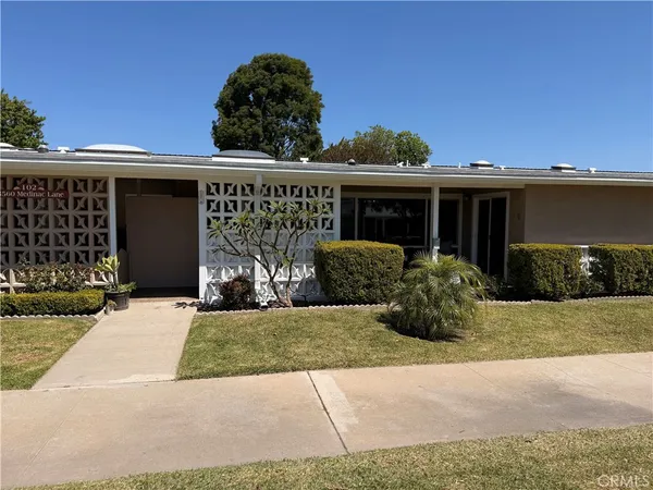 a view of a house with a yard and a garage