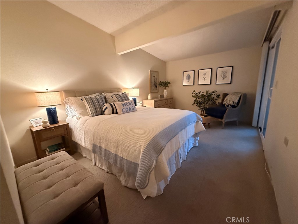 13560 Medinac Lane, Unit 102B Seal Beach, CA 90740 - Photo 14 of 24 a bedroom with a bed and a couch