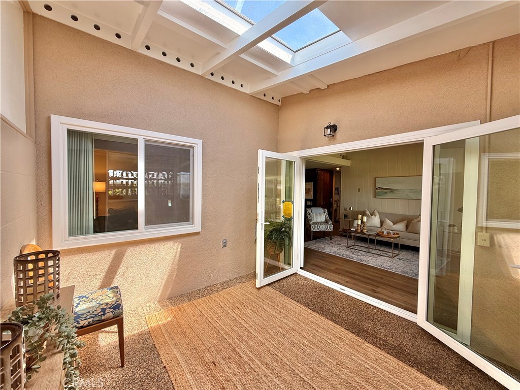 13560 Medinac Lane, Unit 102B Seal Beach, CA 90740 - Photo 17 of 24 a view of a room with wooden floor and furniture