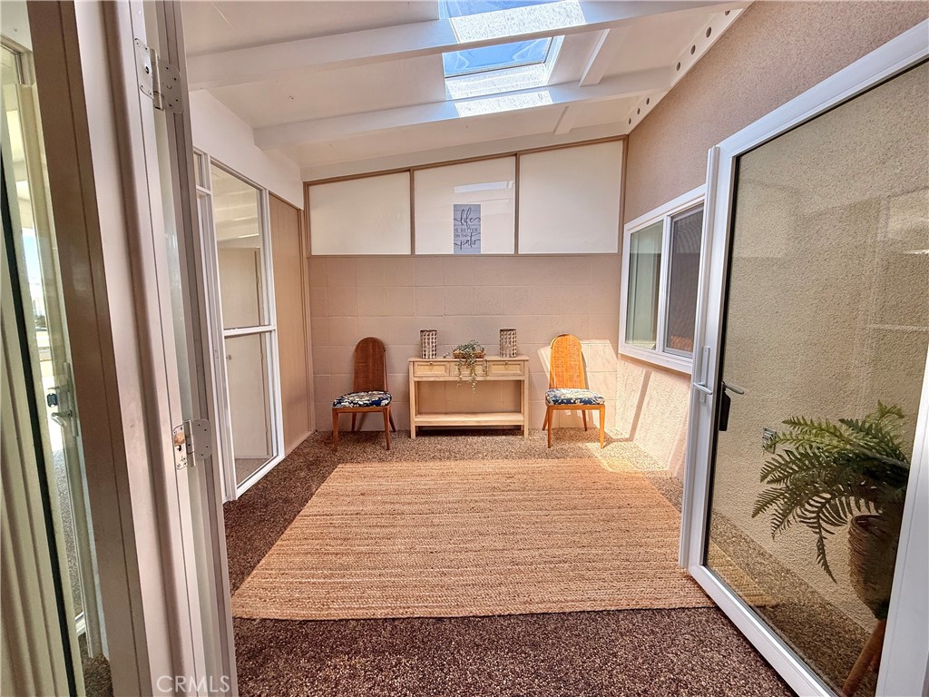 13560 Medinac Lane, Unit 102B Seal Beach, CA 90740 - Photo 18 of 24 a living room with furniture and a rug