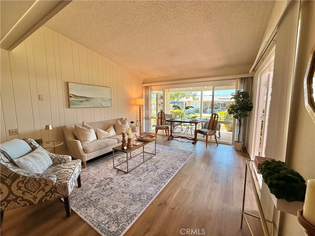 13560 Medinac Lane, Unit 102B Seal Beach, CA 90740 - Photo 2 of 24 a living room with furniture and a large window