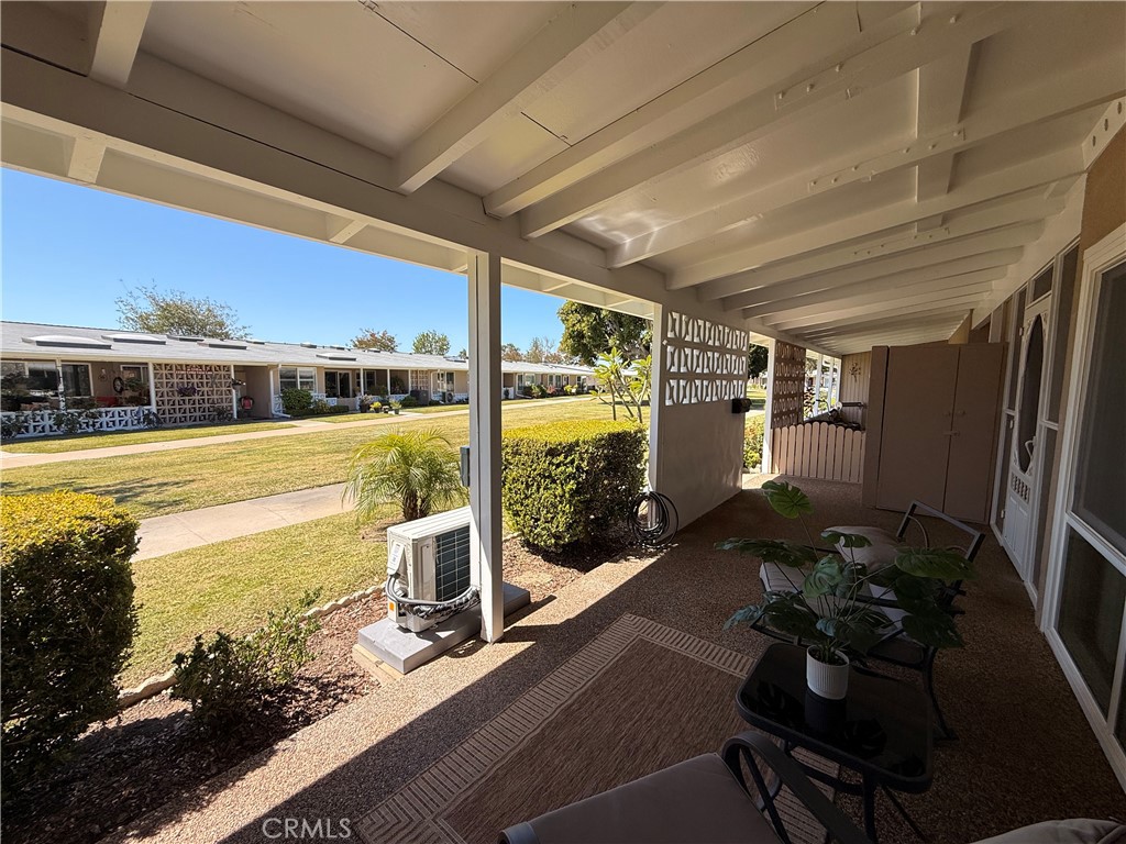 13560 Medinac Lane, Unit 102B Seal Beach, CA 90740 - Photo 22 of 24 a view of a balcony with chair and wooden floor