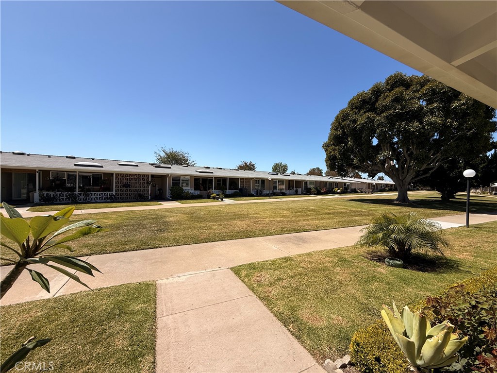 13560 Medinac Lane, Unit 102B Seal Beach, CA 90740 - Photo 23 of 24 a front view of a house with a yard