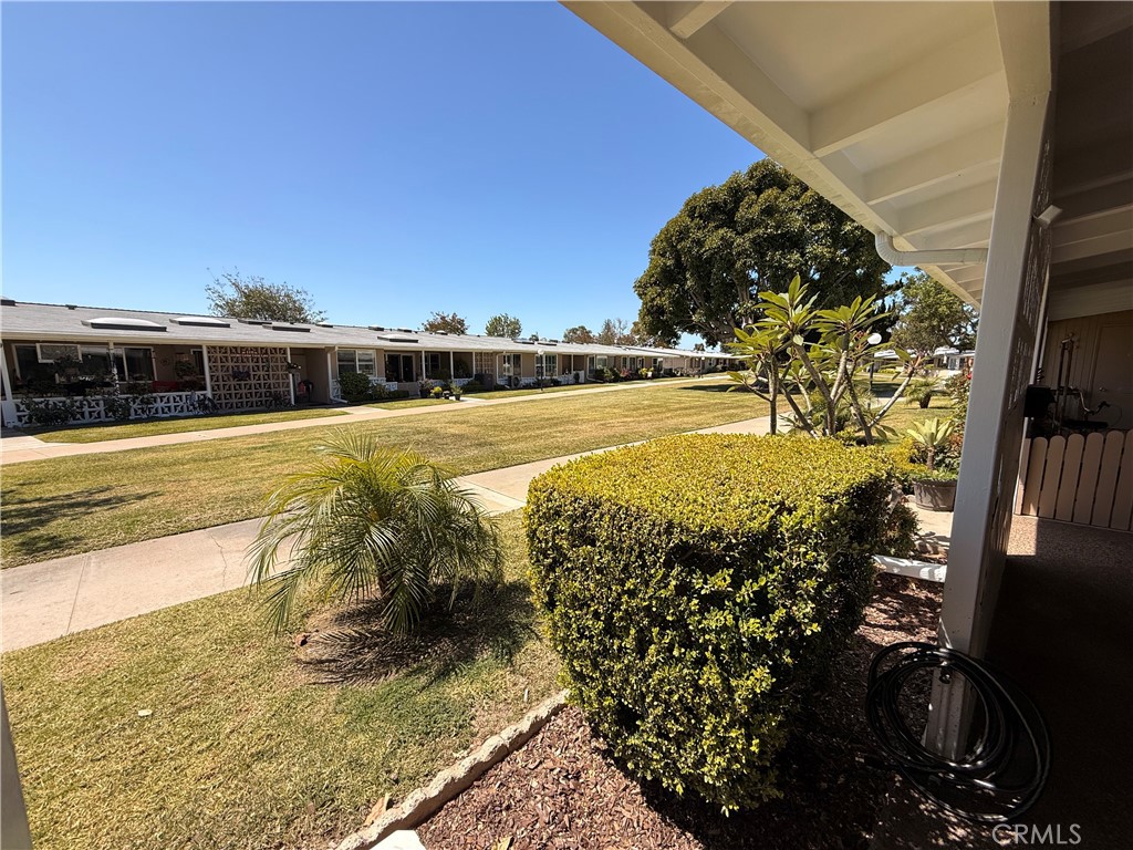 13560 Medinac Lane, Unit 102B Seal Beach, CA 90740 - Photo 24 of 24 a view of a swimming pool with an outdoor seating and a yard