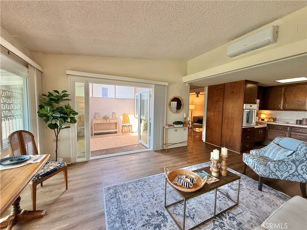 13560 Medinac Lane, Unit 102B Seal Beach, CA 90740 - Photo 4 of 24 a living room with furniture and a potted plant