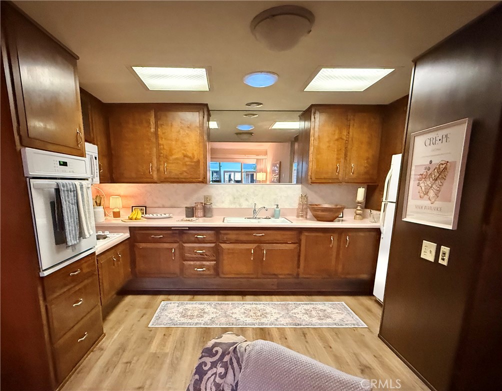 13560 Medinac Lane, Unit 102B Seal Beach, CA 90740 - Photo 6 of 24 a kitchen with stainless steel appliances granite countertop a sink stove and refrigerator