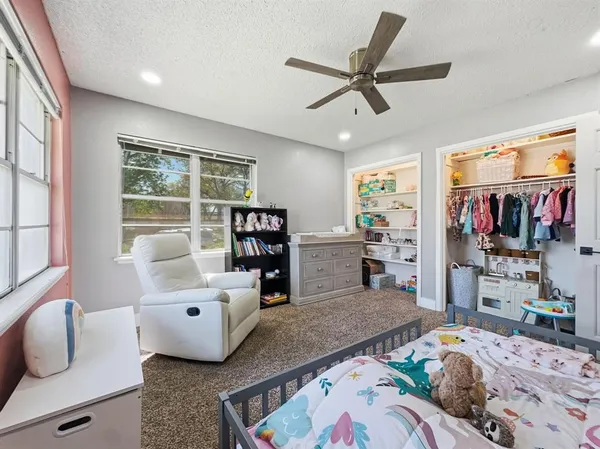 a bedroom with furniture and a window