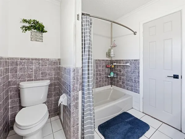a white toilet sitting next to a bathroom sink and tub