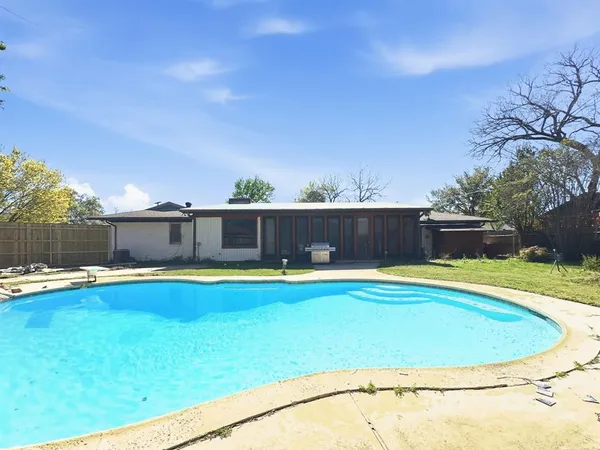 a view of a swimming pool and a yard