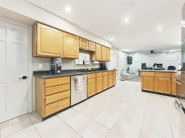 a kitchen with stainless steel appliances granite countertop a sink and cabinets