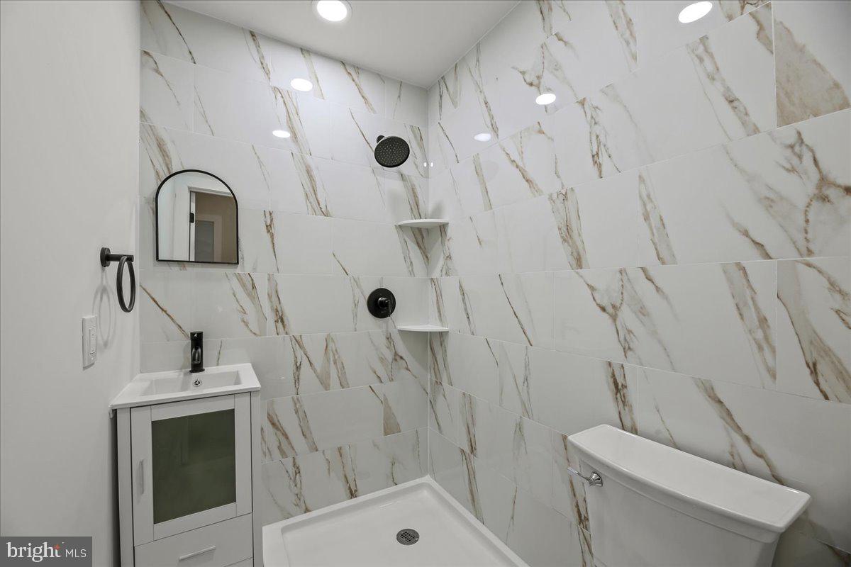 19 Intrepid Drive Sewell, NJ 08080 - Photo 18 of 47 a bathroom with a sink a toilet and shower