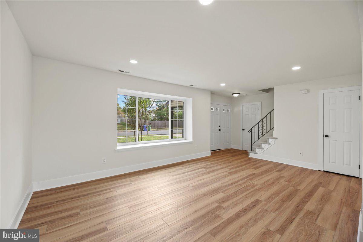19 Intrepid Drive Sewell, NJ 08080 - Photo 5 of 47 a view of an empty room with wooden floor and a window
